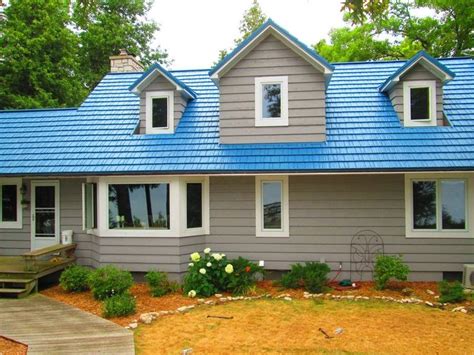 yellow house with blue metal roof|exterior house colors brown roof.